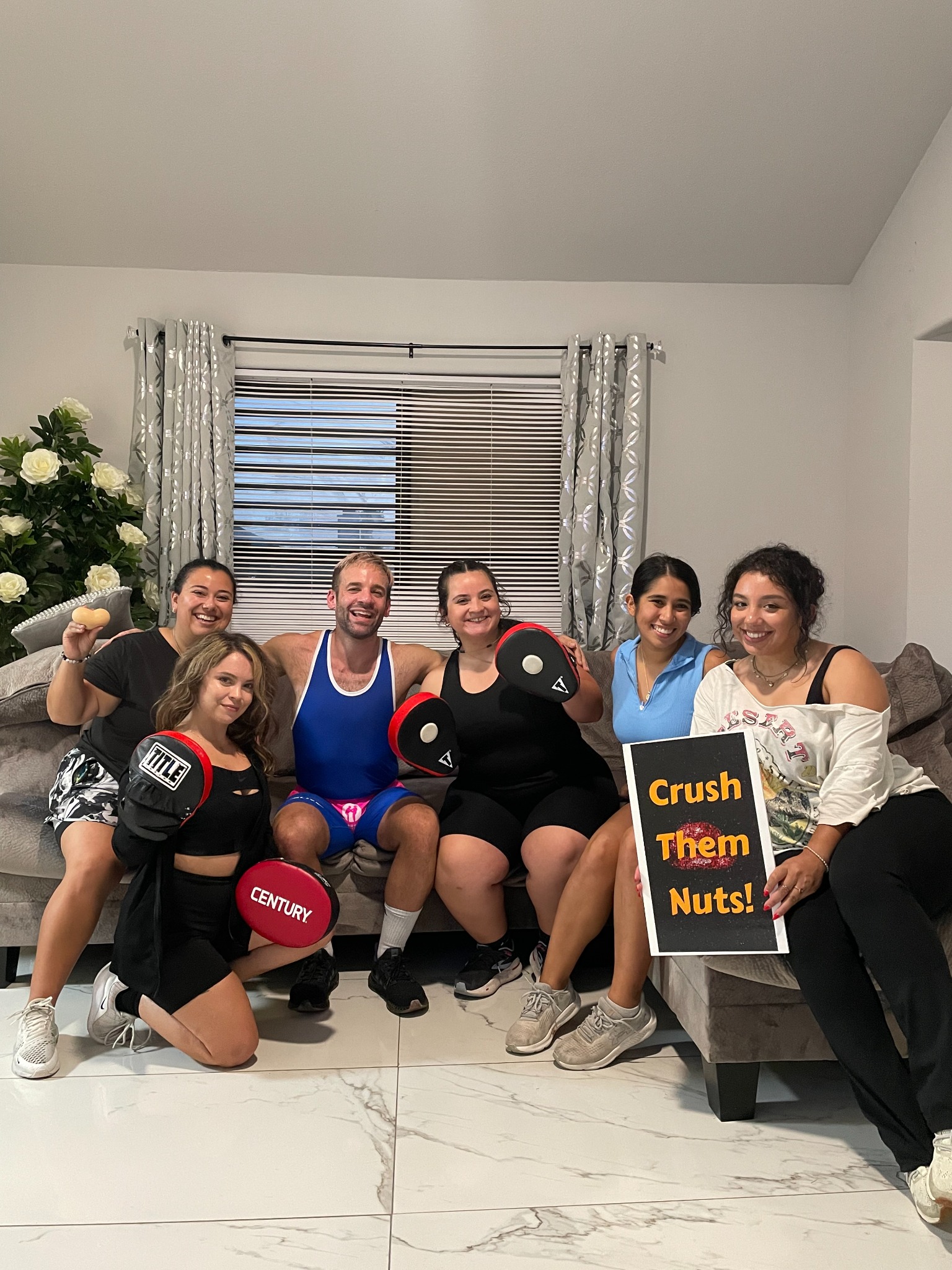 A smiling bachelorette group with Jesse after their private self-defense party