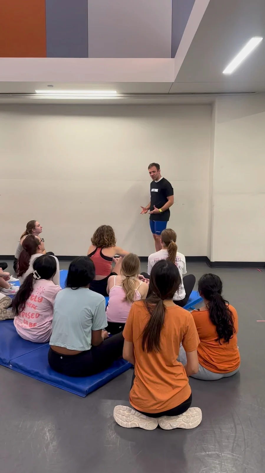 Jesse teaching a seated group of women during a self-defense class